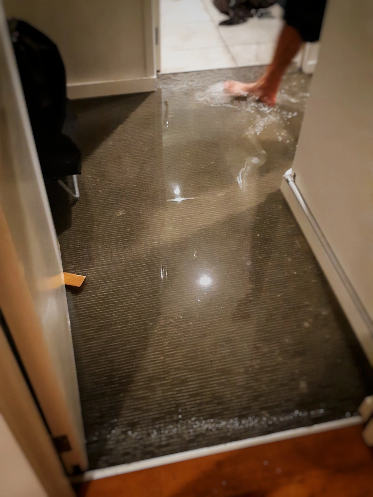 flood water in front of bathroom on carpet