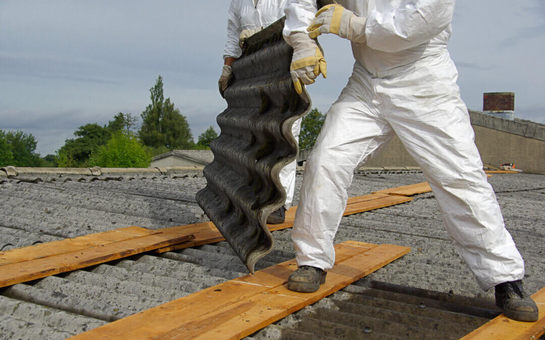 Worker removing asbestos safely with protective gear during Asbestos Awareness Week