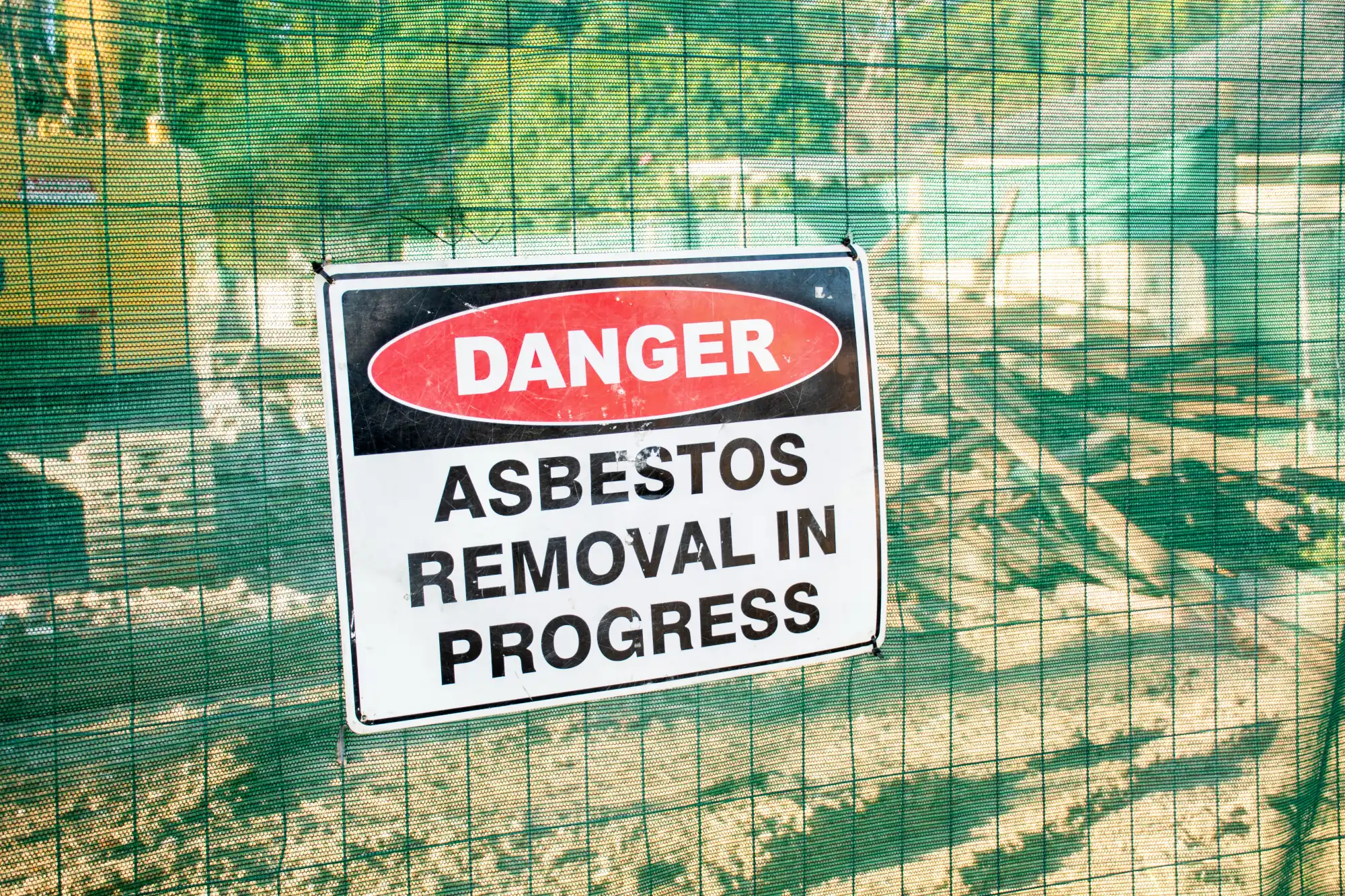 Asbestos removal danger sign on fence mesh
